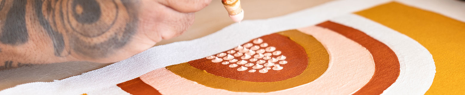 Close up image of hand with paintbrush painting